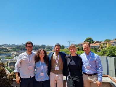 five researchers smiling outdoors 